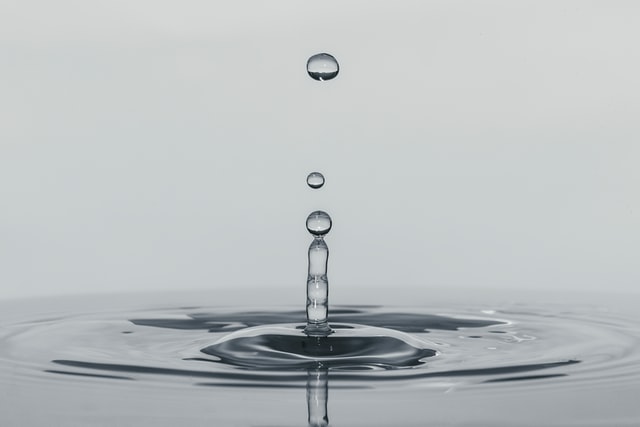 Slow motion image of a drip slashing in water.