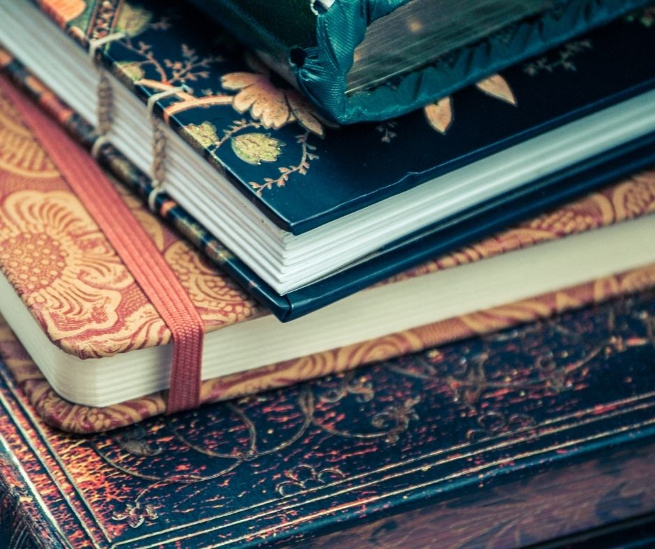 Handmade journals in colors blue, orange, and patterns.