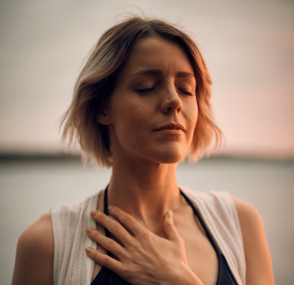 Lady with hand on her heart.