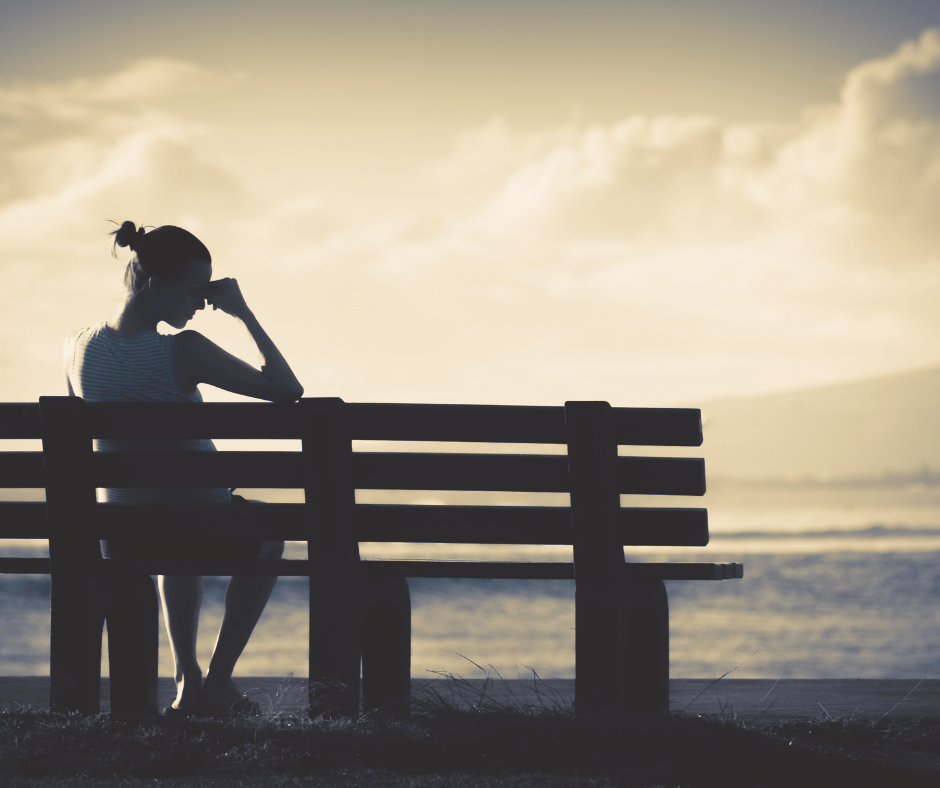woman distressed sitting on bench