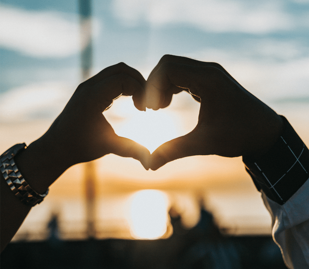 Male and female hand making a heart