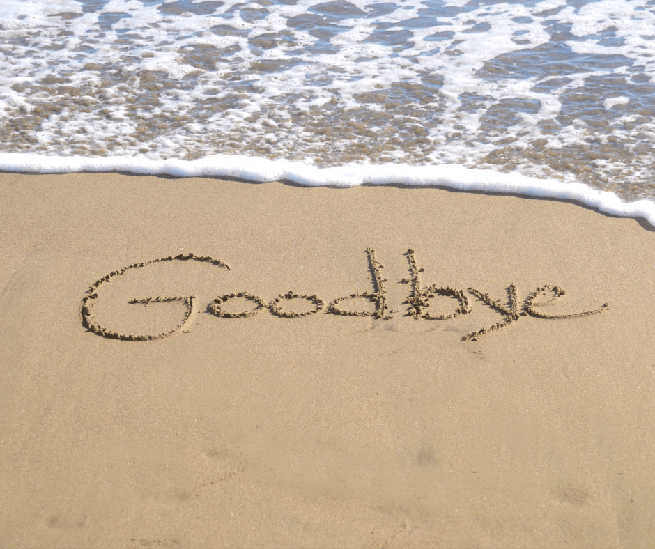goodbye written in the sand on the shore line!